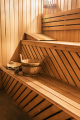 Fototapeta na wymiar wooden sauna cabin with sauna accessories, bucket, broom, oak scoop