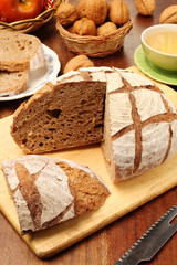 Country bread on the wooden cutting board    