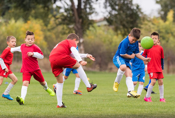 Obraz na płótnie Canvas Young children players football match on soccer field