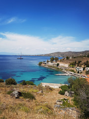 Fototapeta na wymiar Sunny landscape with a yacht on the island of Aegina