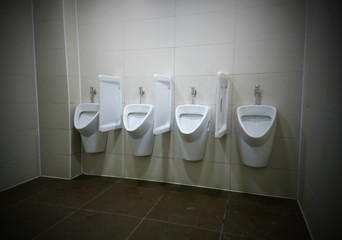 modern restroom interior with urinal row