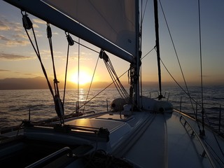 Mast of the yacht at sunrise at sea