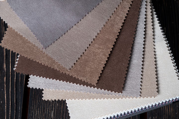 Color fabric samples palette on wood background. Brown colors