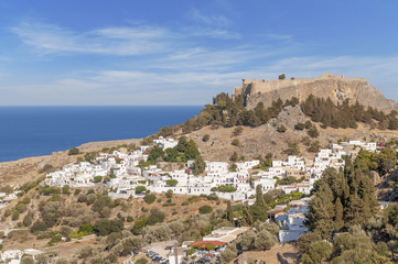 Castle view Acropolis of city Lindos of Rhodes island with big blue cloudy sky