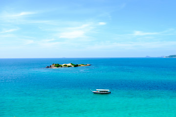 Fototapeta na wymiar The boat and island in beautiful sea on the day of bright skies