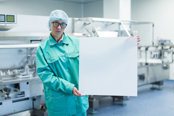 pharmaceutical factory worker shows Equipment