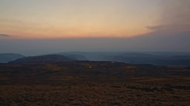 Pan of empty landscape at sunset from summit of Steens Mountain in fall 2