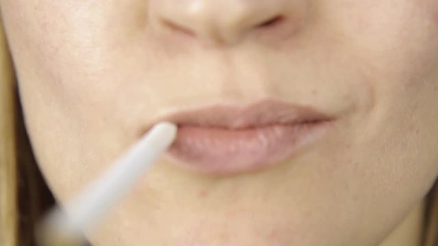 Closeup of woman without makeup smoking, only lips view