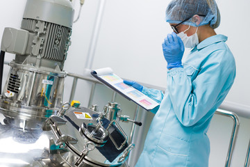 scientist monitors the readings on the equipment