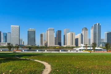 Fototapeta na wymiar green lawn with city skyline background, tianjin china.