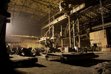 Dark abandoned rusted ruined industrial interior at night. Voronezh excavator plant