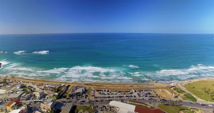 Aerial shot flying backwards of Jaffa Beach and the Mediterranean Sea