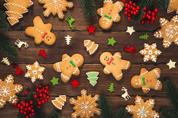 Christmas background with homemade gingerbread cookies and New Year decor on old wooden background....