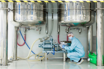 scientist is working under tanks