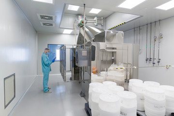 scientist stand near control panel