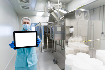scientist show empty tablet near steel machine