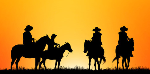 silhouette cowboy and horse on blurry colorful sunset sky.