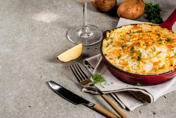 Skillet Shepherd's Pie, british casserole in cast iron pan, with minced meat, mashed potatoes and vegetables, on gray stone background, copy space