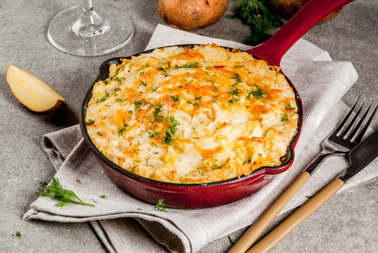Skillet Shepherd's Pie, british casserole in cast iron pan, with minced meat, mashed potatoes and vegetables, on gray stone background, copy space top view