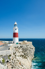 Fototapeta na wymiar Europa Point Lighthouse (Trinity Lighthouse or Victoria Tower) on the cliff. British Overseas Territory of Gibraltar.