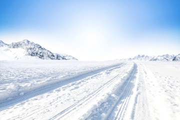 Winter Background of foreground of road covered with snow and ice. In the background, the arctic...