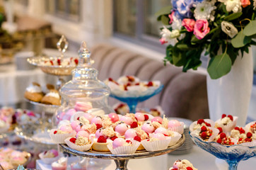 Obraz na płótnie Canvas Delicious wedding reception candy bar dessert table full with panacota and edible silver. Luxury life.
