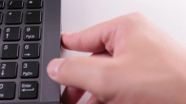 パソコンからディスクを取り出す手元