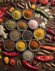 Spices and herbs in wooden bowls. Food and cuisine ingredients