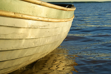 board of a wooden boat standing on the water, closeup
