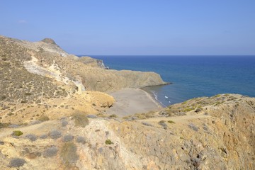 Fototapeta na wymiar View of a secret beach near Monsul in the andalusian desert coast of the Cabo de Gata Níjar Natural Park, Almeria, Andalusia, Spain