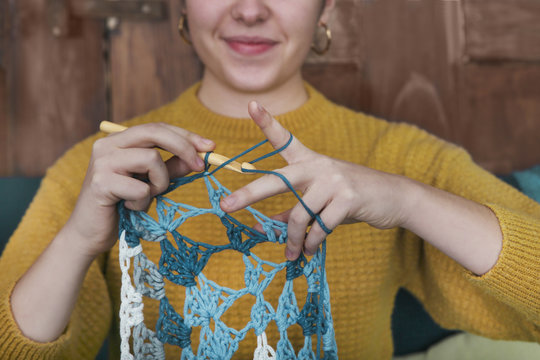 Young woman crocheting doily, close-up