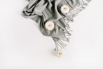 White pumpkins on grey plaid. Top view, flat lay autumn or winter minimal concept.