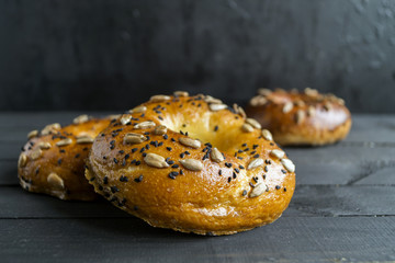Bagels with seeds on a black background.