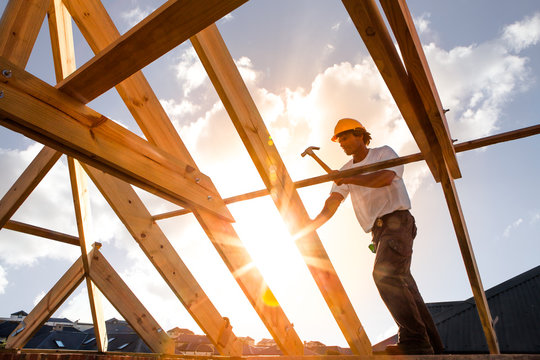 Roofer ,carpenter Working On Roof Structure At Construction Site