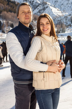 Loving couple skating together holding hands
