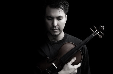 emotion portrait of asian handsome musician posing on violin, isolated on black