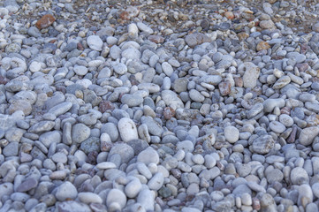 Close up texture of a lot pebble stone on the beach background