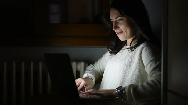 Young beautiful woman using computer sitting on a armchair - business, technology, social network concept
