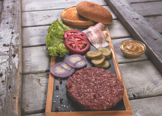 homemade hamburger  fresh ingredients  bun, salted cucumber, beef patties,bacon