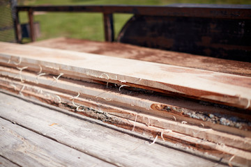 Freshly cut rough sawed planks of lumber