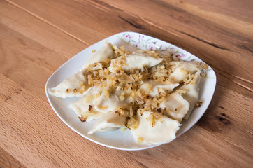 Dumplings on a plate with fried onion