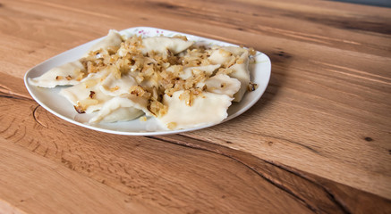 Dumplings on a plate with fried onion