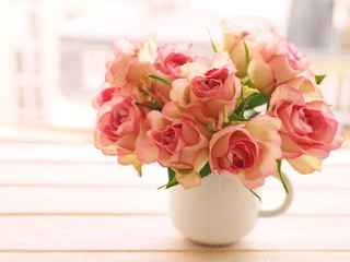 Bouquet of pink roses in white mug