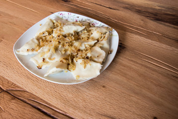 Dumplings on a plate with fried onion