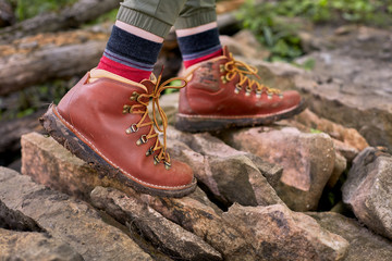 Hiker in boots walking over rocks