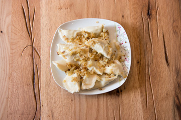 Dumplings on a plate with fried onion