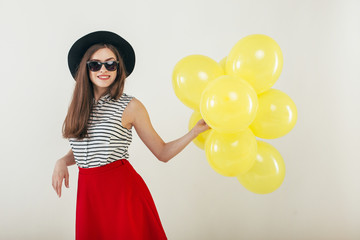 Young pretty woman with yellow balloons
