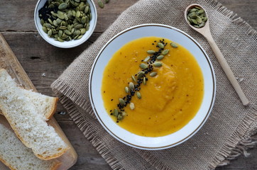Pumpkin soup with seeds, black cumin and coriander in a bowl