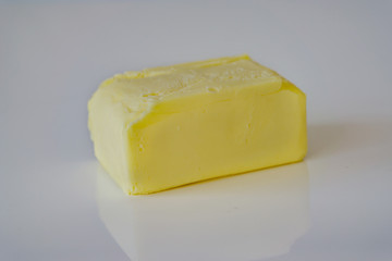 Close up of open pack of butter on white backgraund. Shallow depth of focus.