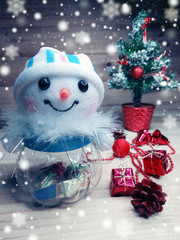 snowman christmas decoration composition with fir branches and snow